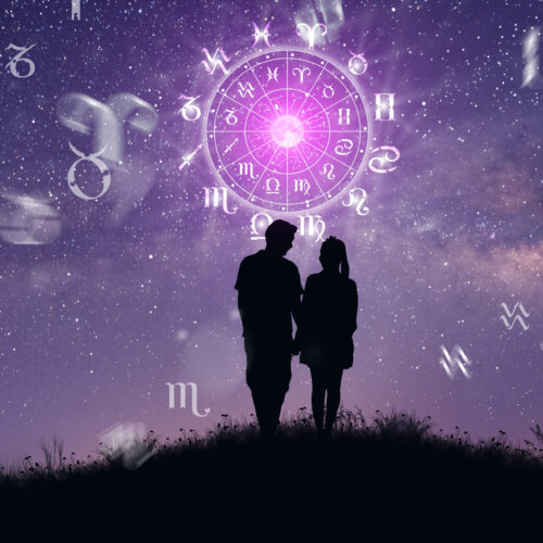 Astrological zodiac signs inside of horoscope circle. Couple singing and dancing over the zodiac wheel and milky way background. The power of the universe concept